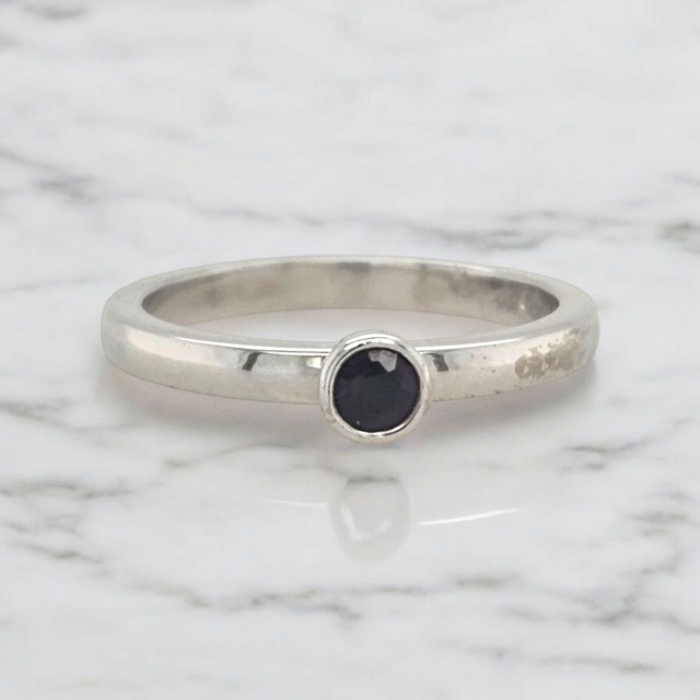 Witgouden ring met een klein granaatje. #26899