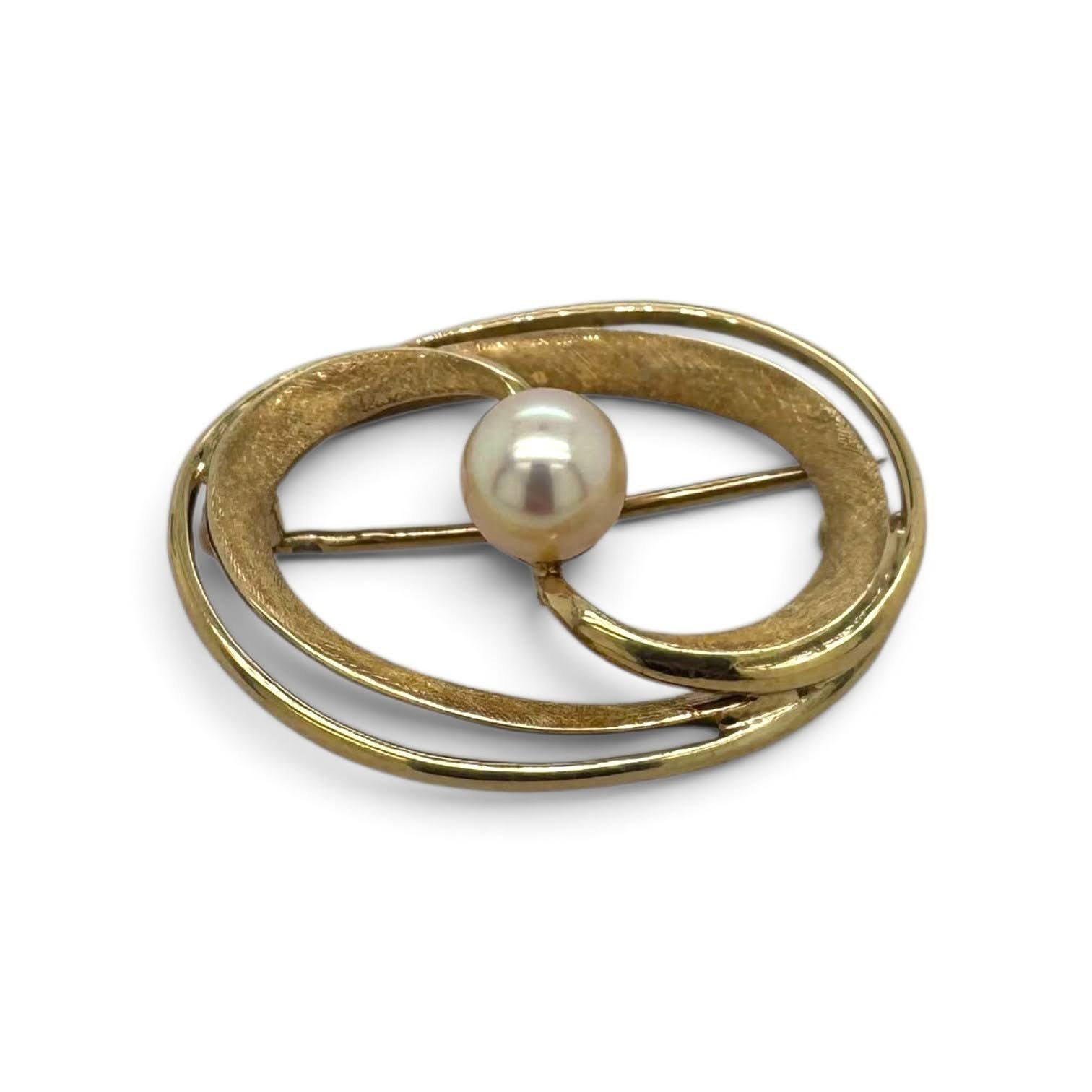 Vintage gouden cirkelbroche met geometrisch ontwerp en parel